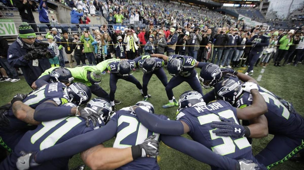 Seattle Seahawks players huddle as they take the field during warmups before facing off against the Philadelphia Eagles on Sunday at CenturyLink Field.