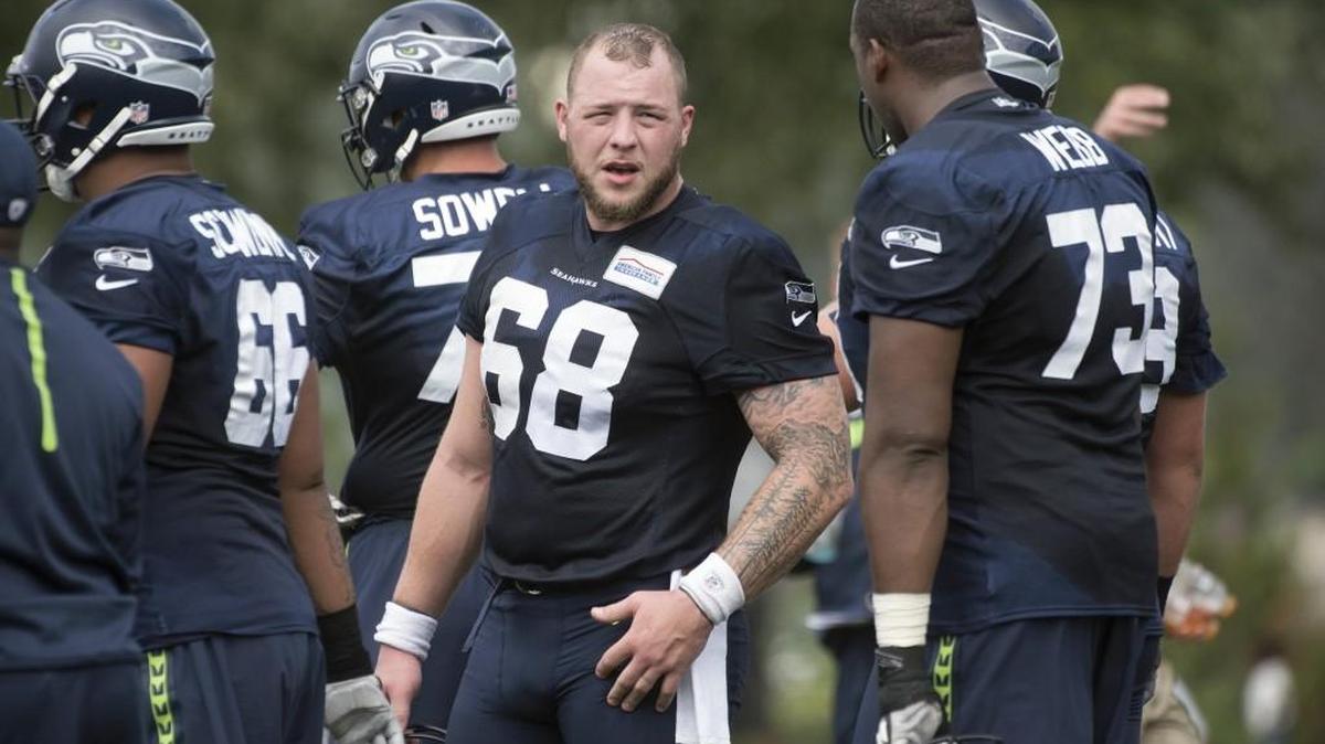 Seattle Seahawks center Justin Britt (68) talks with tackle J’Marcus Webb (73) during practice at the team’s Virginia Mason Athletic Complex in Renton on July 30.