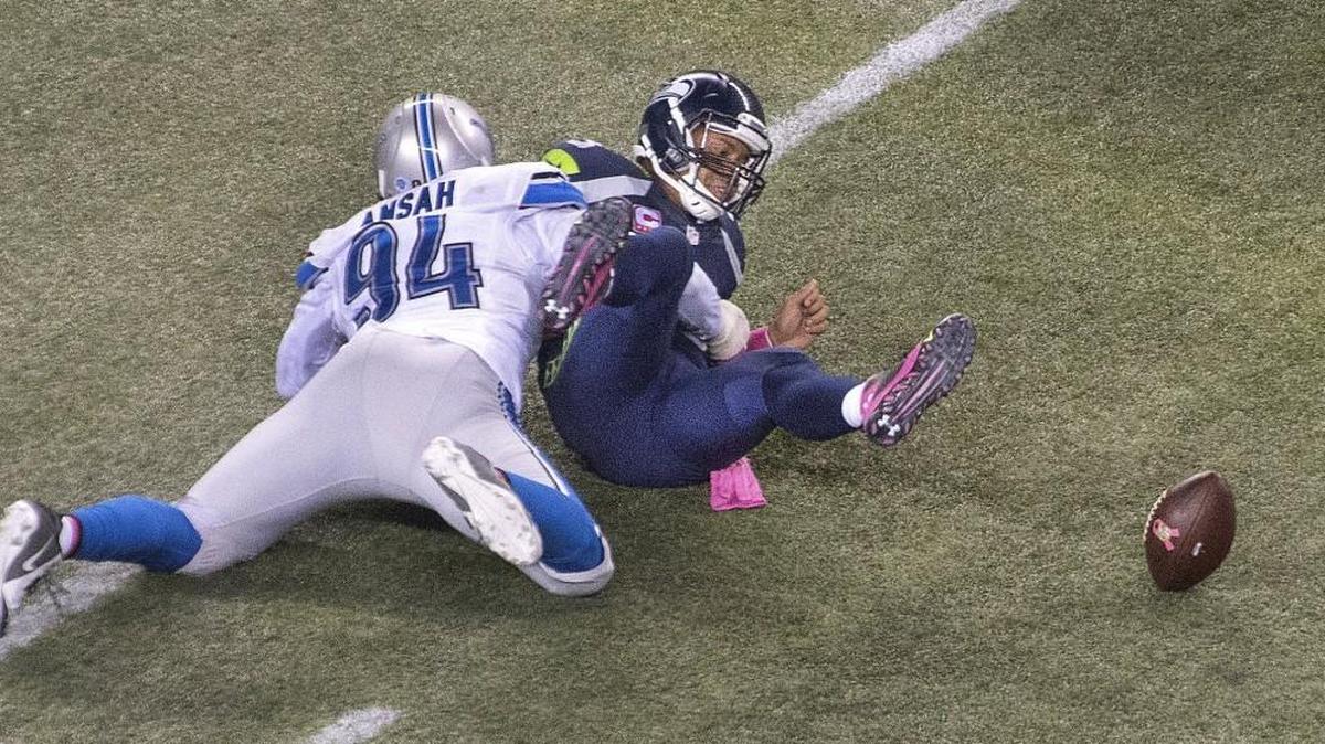
Seattle quarterback Russell Wilson fumbles after being sacked by Detroit lineman Ezekiel Ansah in the second half. Photo taken in Seattle on Monday, Oct. 5, 2015.
