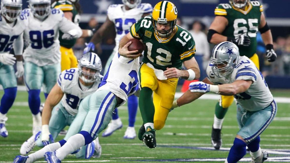Green Bay quarterback Aaron Rodgers (12) rushes for a gain as Dallas’ Sean Lee (50) and Anthony Brown (30) defend during the second half of an NFL divisional playoff game Jan. 15, 2017, in Arlington, Texas.