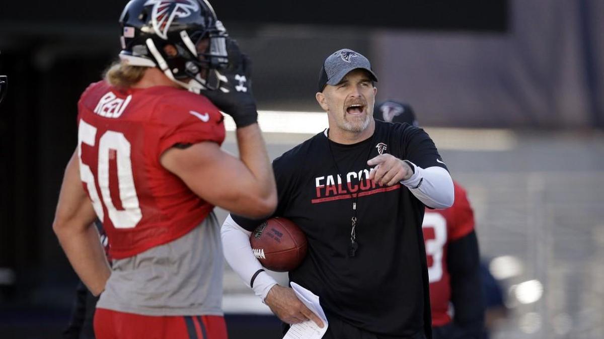 Atlanta Falcons head coach Dan Quinn, right, motions as A.J. Hawk stands nearby during a practice at the University of Washington Wednesday in Seattle. Quinn’s return to Seattle poses an interesting challenge to the coach who was the team’s defensive coordinator.