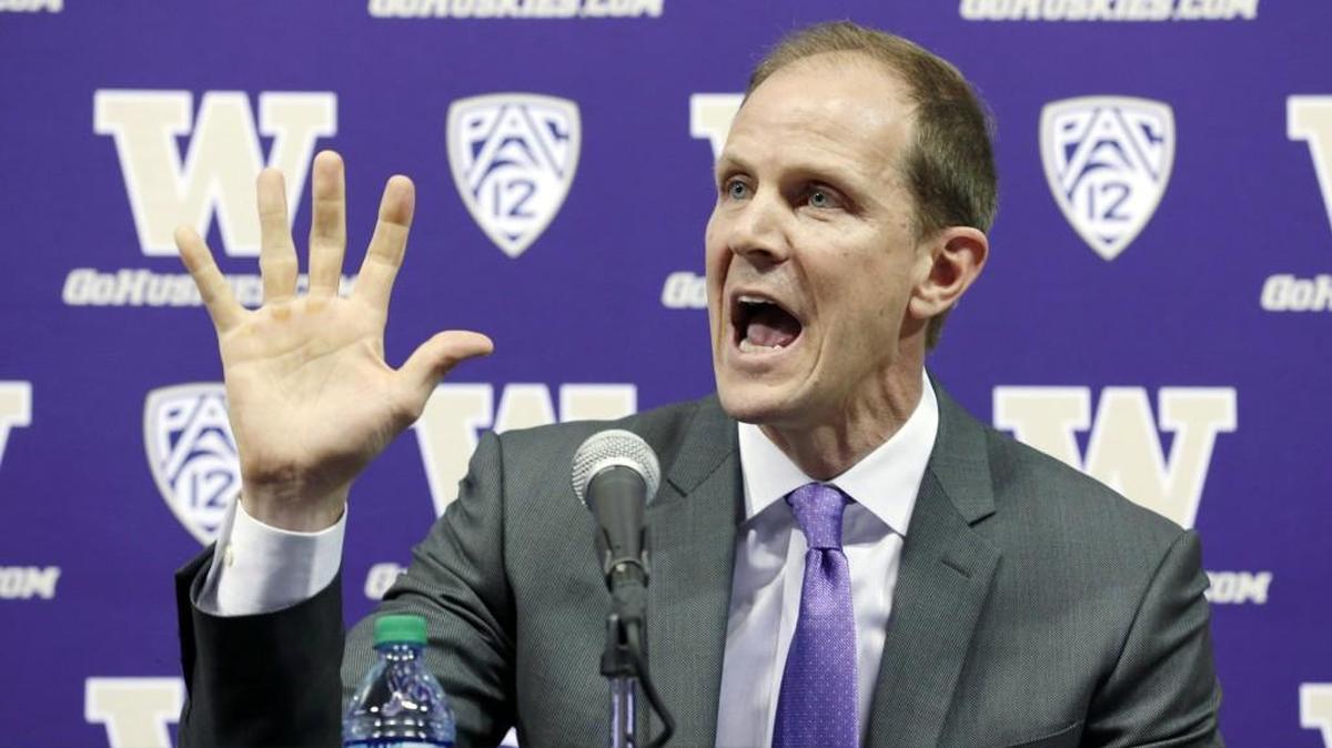 Mike Hopkins talks to reporters after he was introduced as Washington's new head NCAA college basketball coach, Wednesday, March 22, 2017, in Seattle. Hopkins, a longtime Syracuse assistant coach, replaces Lorenzo Romar.