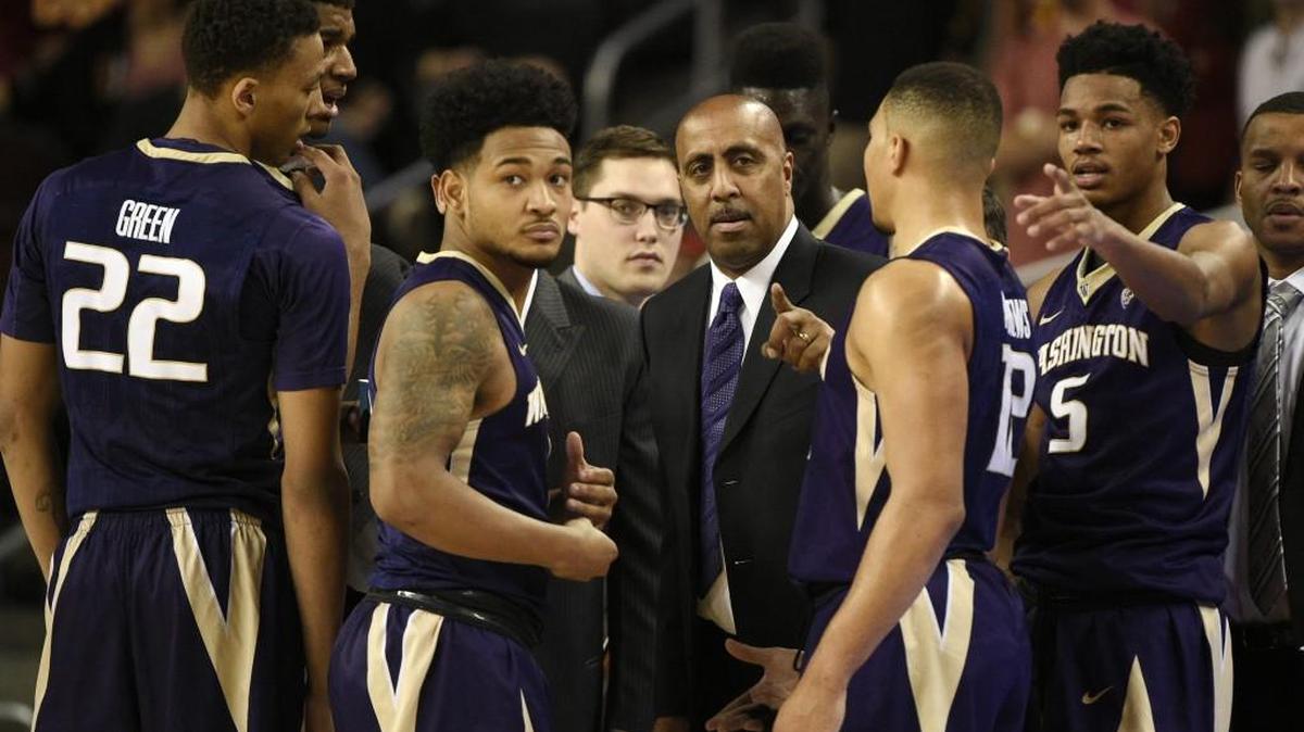 Washington men’s basketball coach Lorenzo Romar, center, last took his Huskies to an NCAA tournament in the 2011 season.