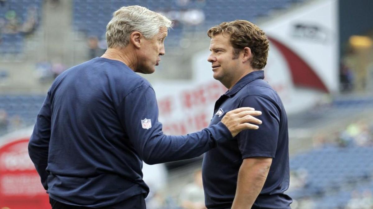 Seattle Seahawks head coach Pete Carroll, left, and general manager John Schneider, right, made their biggest moves of the year’s NFL free agency by keeping quarterback Russell Wilson and linebacker Bobby Wagner out of it.