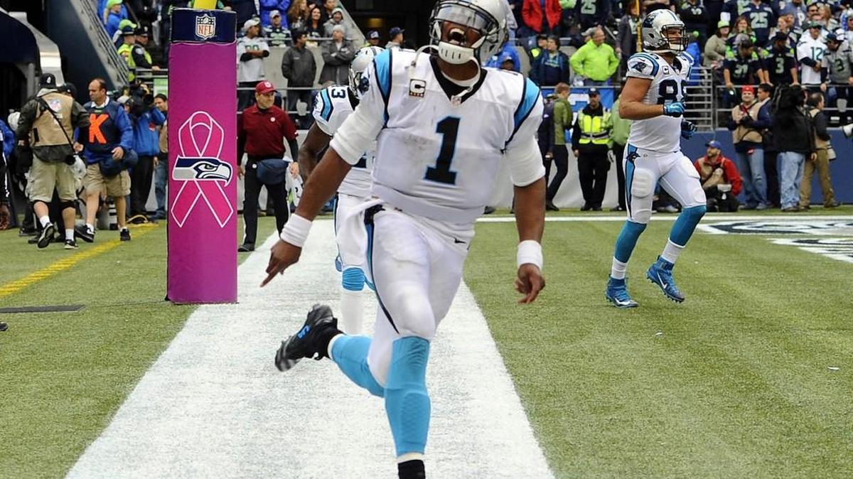 Carolina Panthers' Cam Newton (1) celebrates throwing a game-winning touchdown to Greg Olsen (88) against the Seattle Seahawks in the fourth quarter at CenturyLink Field on Sunday, Oct. 18, 2015 in Seattle. The Panthers won, 27-23.