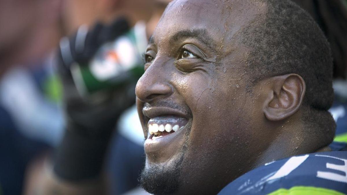 Seahawks offensive lineman J’Marcus Webb smiles on the sidelines late in Sunday’s game against the San Francisco 49ers at CenturyLink Field.