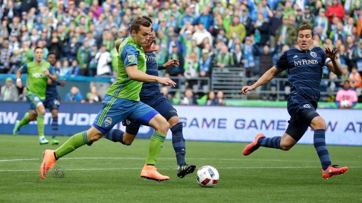Mercer Island native and Sounders rookie Jordan Morris, left, prepares to make a shot on goal as Sporting Kansas City defender Amadou Dia, second from left, and defender Matt Besler, right, defend.