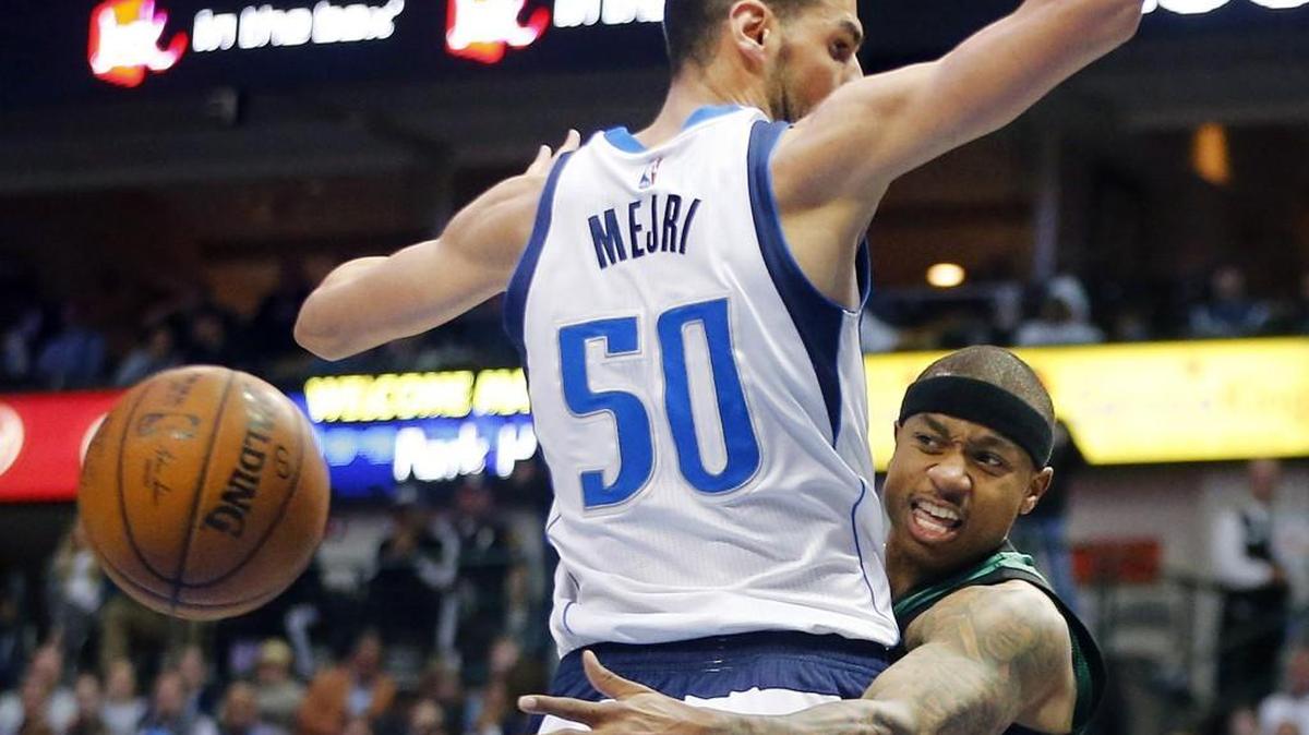 Boston Celtics guard Isaiah Thomas, right, passes around Mavericks center Salah Mejri. Thomas was a star at Curtis High School and the University of Washington.