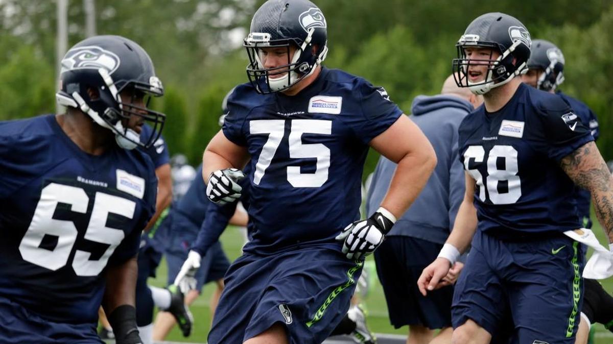 Seattle Seahawks offensive linemen Patrick Lewis (65), Will Pericak (75) and Justin Britt run through drills Thursday in Renton. Expect it will take a while before the line’s chemistry comes around.