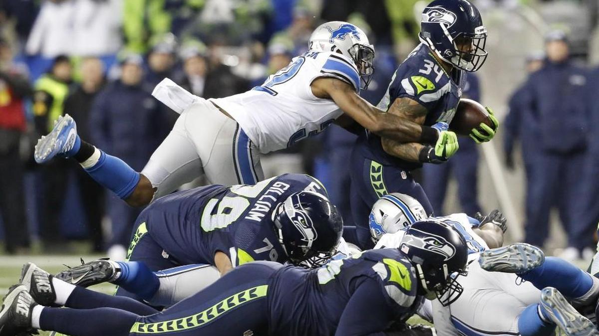 Seahawks running back Thomas Rawls (34) runs through the tackle of Lions safety Tavon Wilson (32). The Seahawks’ offensive line came through with a huge effort in a 26-6 win.