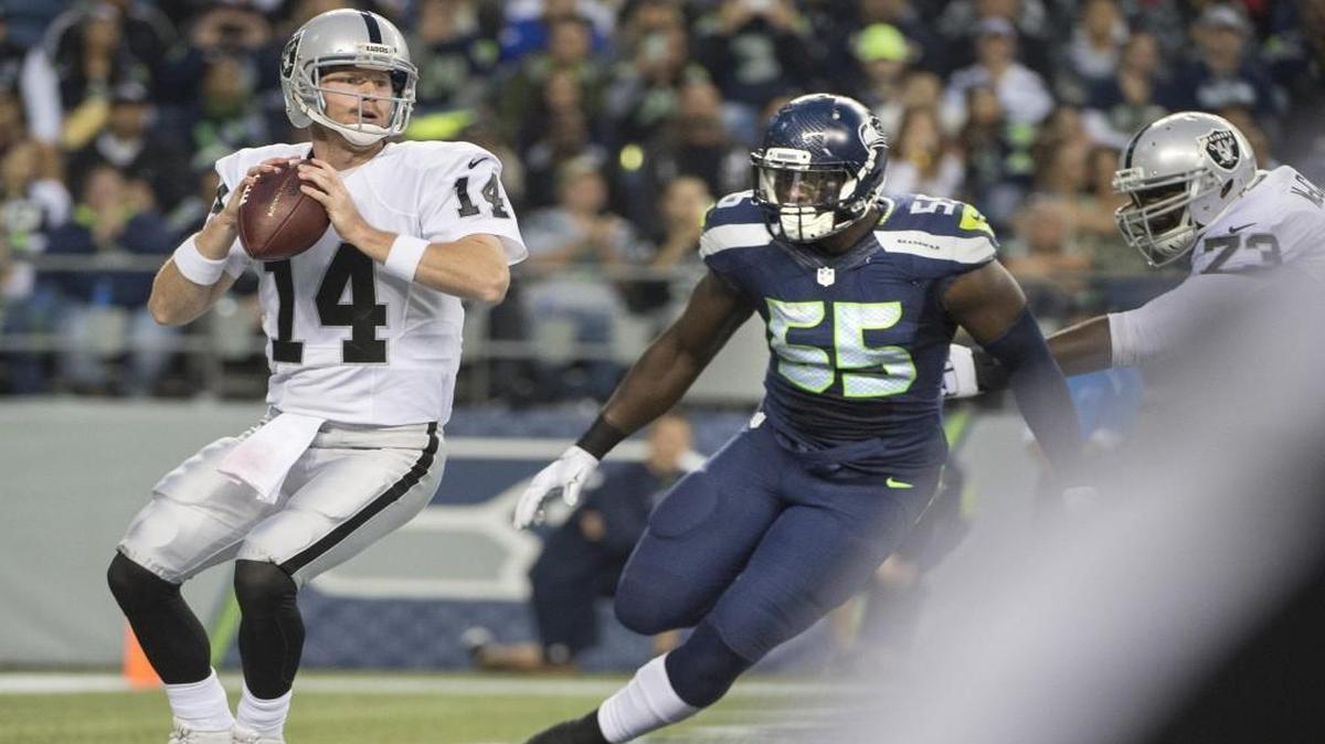 
Seahawks defensive lineman Frank Clark closes in on Raiders quarterback Matt McGloin in the end zone Thursday. Clark forced a fumble that was recovered by Jordan Hill for a Seahawks touchdown.
