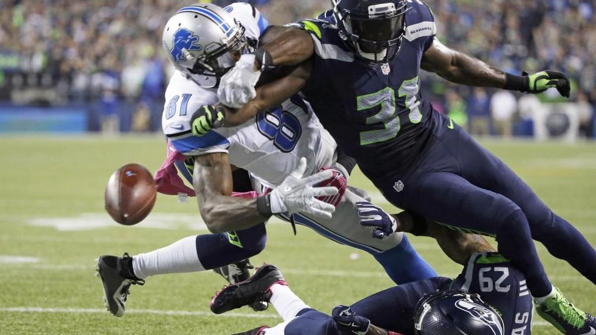Seattle strong safety Kam Chancellor (31) knocks the ball loose from Detroit wide receiver Calvin Johnson (81) on Oct. 5, 2015. The fumble went out of bounds in the end zone and was ruled a touchback. The Seahawks beat the Lions 13-10.