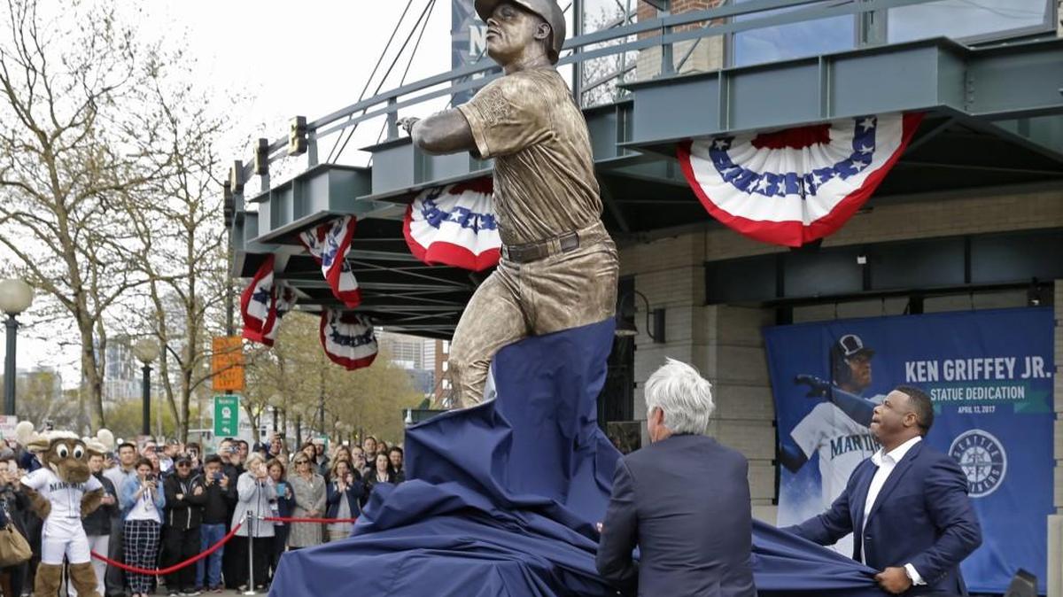 Seattle Mariners Hall of Famer Ken Griffey Jr., right, helps Mariners CEO John Stanton unveil a statue of Griffey on Thursday in front of Safeco Field in Seattle.