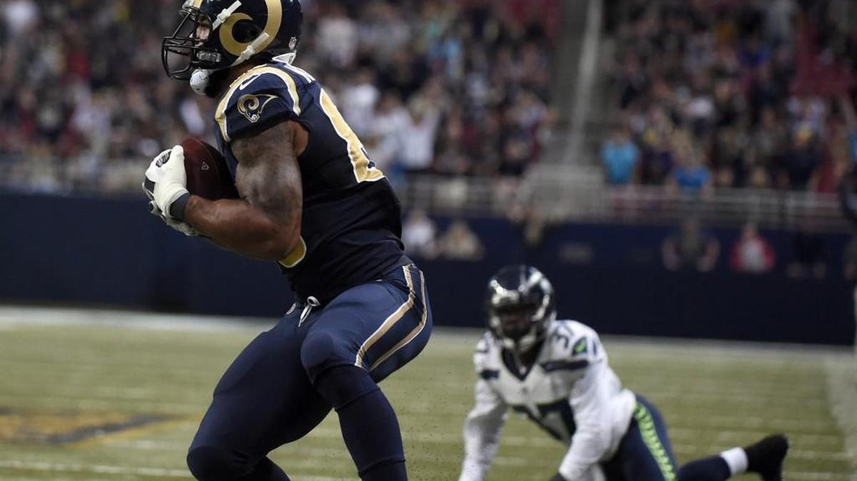 
Rams tight end Lance Kendricks, left, catches a 37-yard pass for a touchdown as Seahawks safety Dion Bailey, right, watches during the fourth quarter of Seattle’s 34-31 overtime loss in St. Louis last week.
