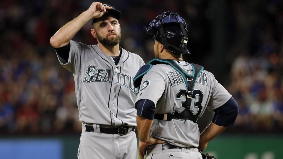 Seattle Mariners starting pitcher Nathan Karns, left, talks with catcher Chris Iannetta in the third inning against the Texas Rangers this past Saturday. Mariners starting pitching, which lost Felix Hernandez to the disabled list, has taken a pounding this past week.