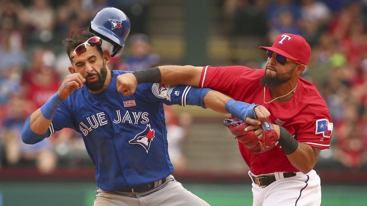 Toronto Blue Jays slugger Jose Bautista (19) gets hit by Texas Rangers second baseman Rougned Odor (12) after Bautista slid into second in the eighth inning Sunday in Arlington, Texas. The Rangers won 7-6.
