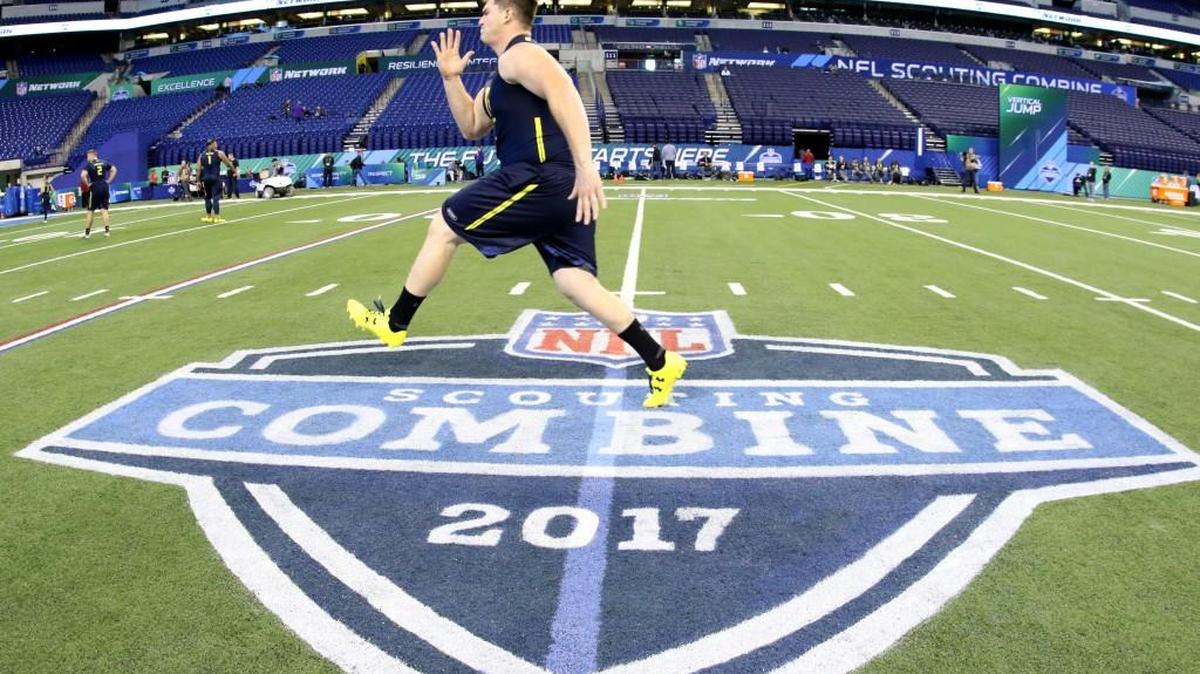 A participants warms up before a drill at the 2017 NFL football scouting combine Friday in Indianapolis.Players train for months in preparation and every NFL team staffs it heavily, but the annual scouting combine is over-covered and mostly superfluous.