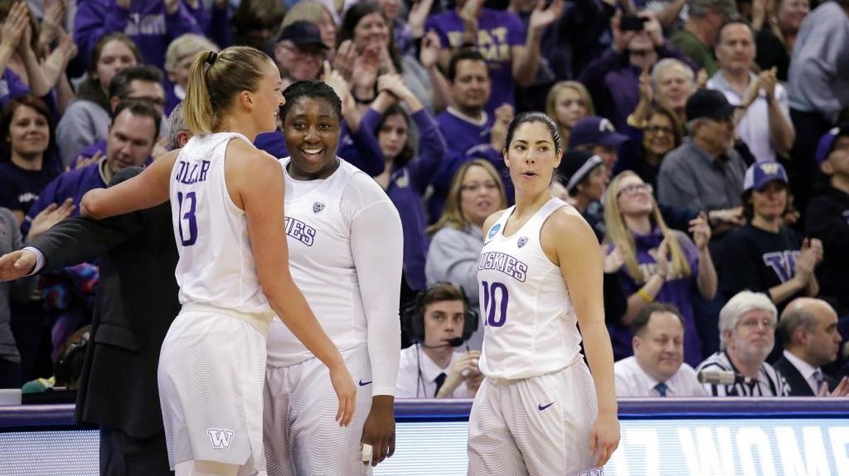 Washington senior starters Kelsey Plum, from right, Chantel Osahor and Katie Collier (13) pause to the applause of fans Monday as all three leave the game in the final minutes of the second half against Oklahoma in the NCAA women’s tournament. Washington won 108-82.