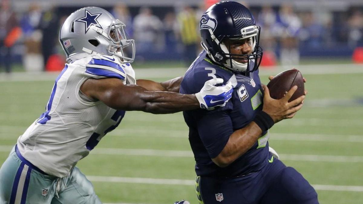 Quarterback Russell Wilson, being chased by Cowboys cornerback Byron Jones, left, must use his legs as well as his arm if the Seahawks are to return to the playoffs this season.