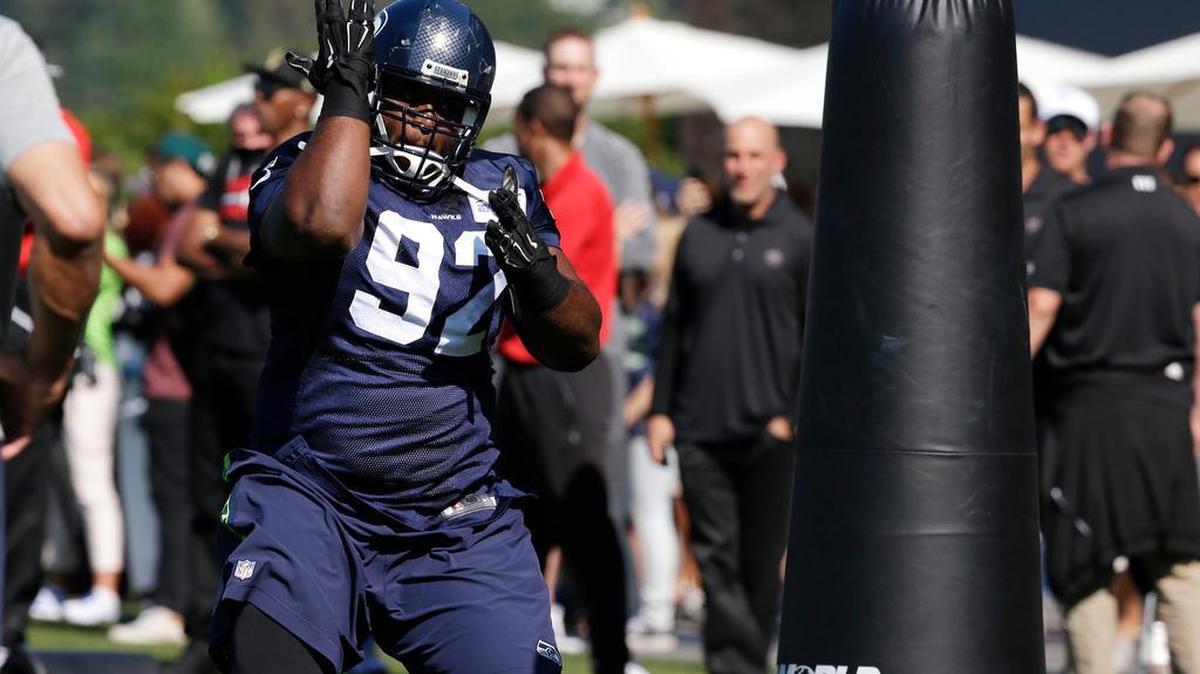 
Seattle Seahawks' Brandon Mebane runs through a drill at an NFL football training camp Wednesday, Aug. 19, 2015, in Renton.
