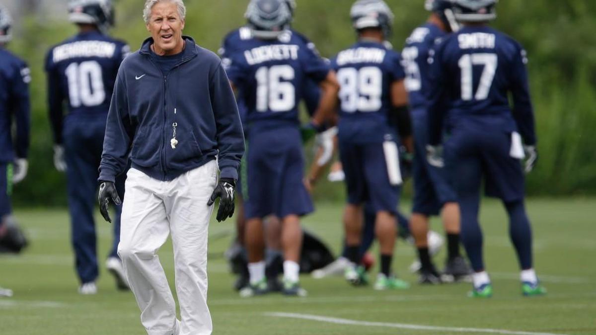 Seattle Seahawks coach Pete Carroll walks on the field during NFL football practice, Thursday, June 9, 2016, in Renton.