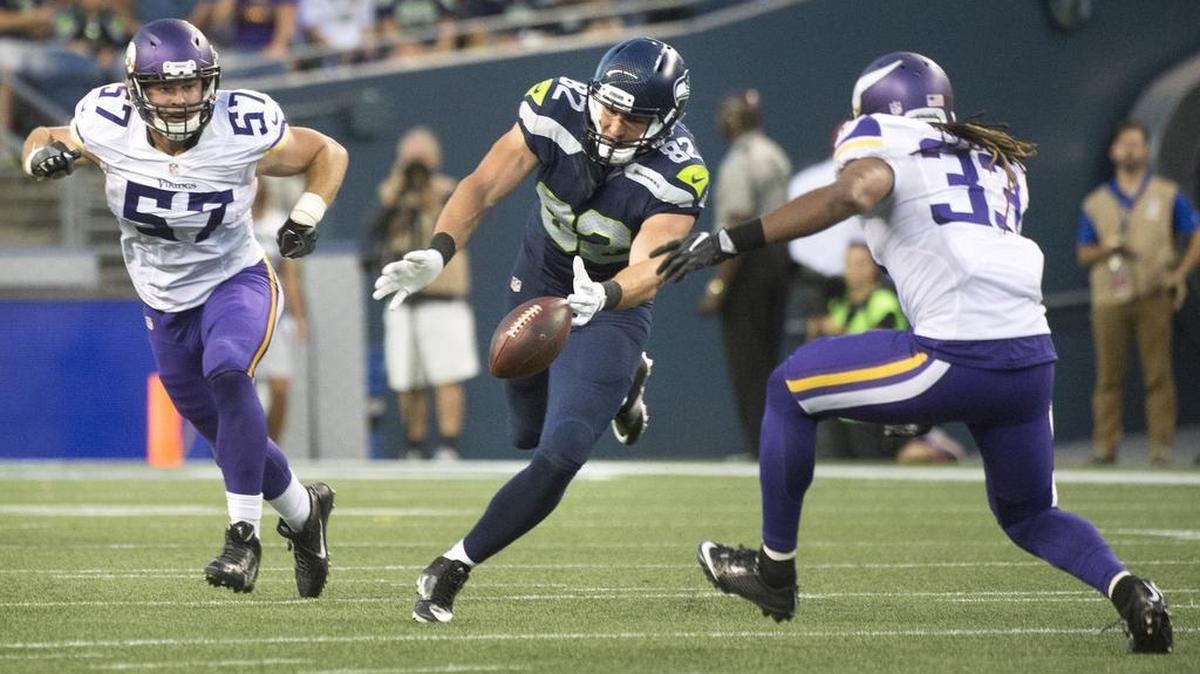 Seattle’s Luke Willson loses the handle on a pass in front of Vikings defenders Audie Cole (57) and Michael Griffin.
