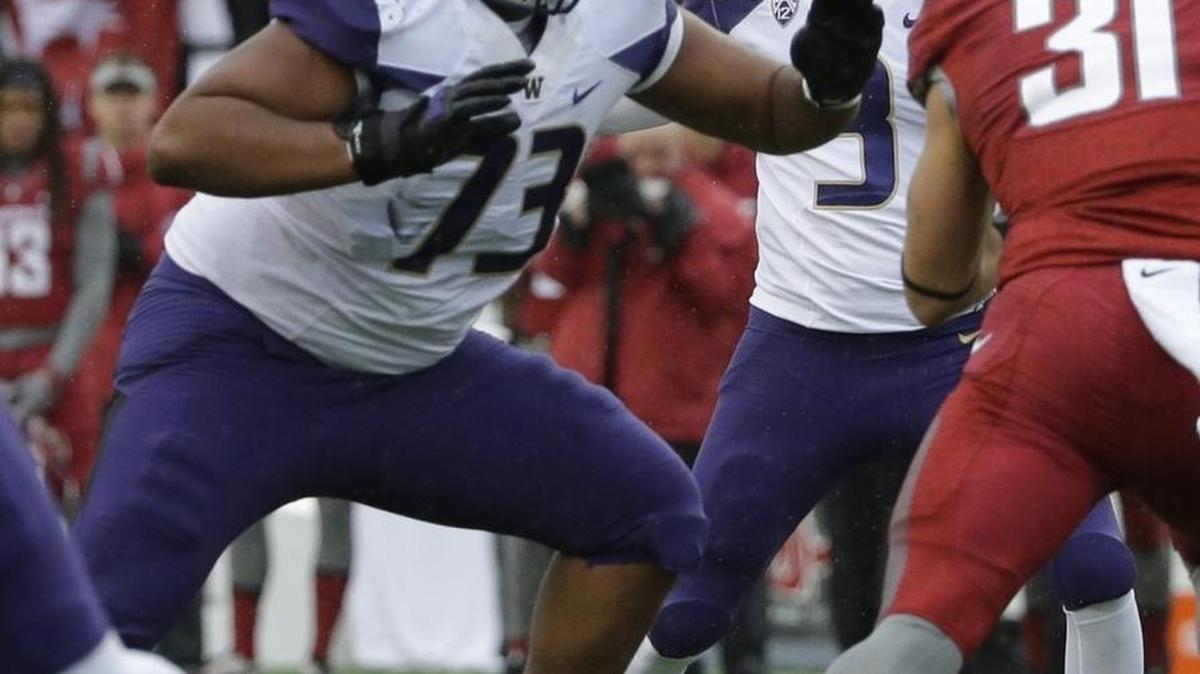 UW right guard Andrew Kirkland (73) blocks for Jake Browning during the Apple Cup against Washington State on Friday. Kirkland and the offensive line didn’t allow Browning to get sacked once in the game.