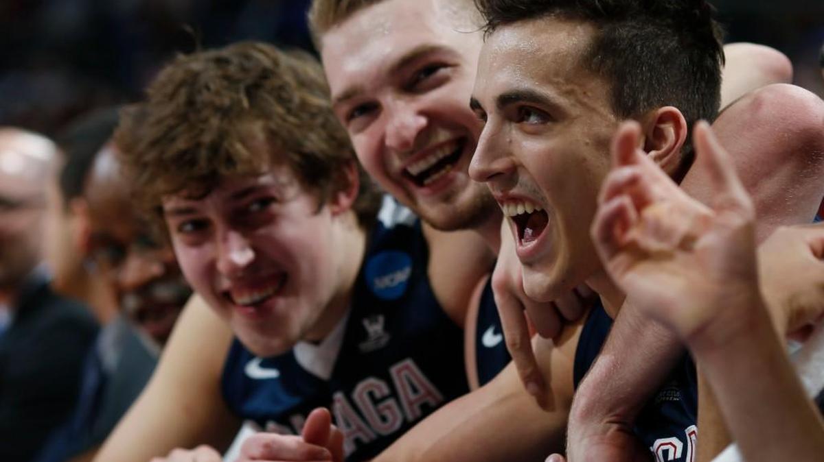 From front, Gonzaga guard Kyle Dranginis celebrates with forwards Domantas Sabonis and Kyle Wiltjer on the bench late in the second half of a second-round men's college basketball game against Utah, Saturday, March 19, 2016, in the NCAA Tournament in Denver. Gonzaga won 82-59.
