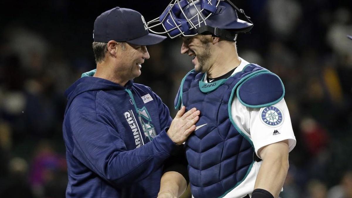 Seattle Mariners catcher Mike Zunino, right, gets congratulated by manager Scott Servais after a big night on Saturday. Zunino drove in seven runs against Tampa Bay and has hit .478 with 11 RBIs over the last seven days.