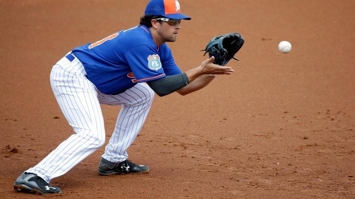 Danny Muno stops a grounder while playing for the Mets in spring training last year. New to the Rainiers, he went 4-for-4 in Wednesday’s win over Fresno.