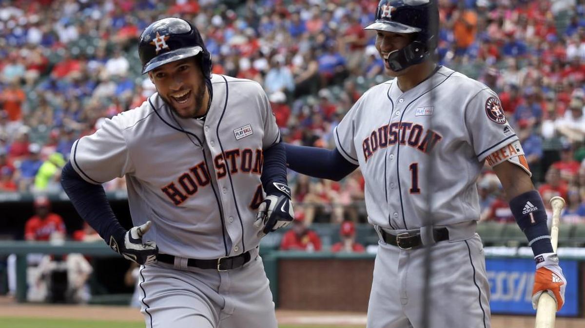 Houston Astros' George Springer, left, and Carlos Correa (1) celebrate Springer's solo home run against the Rangers earlier this season. There’s been plenty of smiles for the first-place Astros so far.