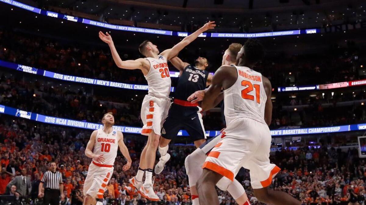 Syracuse’s Tyler Lydon (20) blocks a potential winning shot by Gonzaga’s Josh Perkins (13) in the closing seconds Friday. A blown out-of-bounds call gave the Bulldogs possession when they trailed by a point.