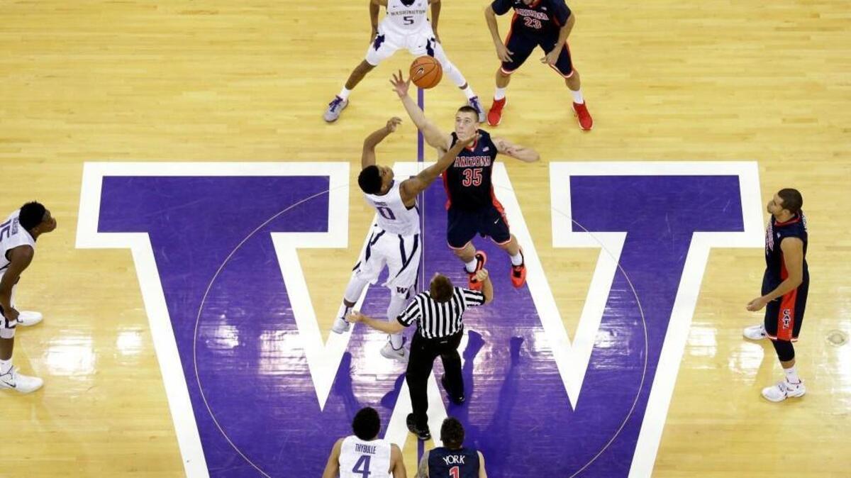 Washington's Marquese Chriss (0) and Arizona's Kaleb Tarczewski tip off to start their Pac-12 showdown Saturday in Seattle.