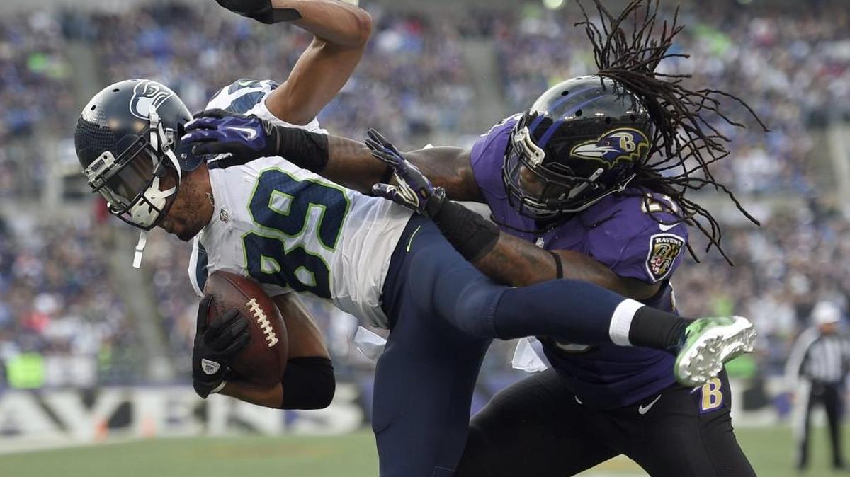 Seahawks wide receiver Doug Baldwin (89) is hit by Ravens free safety Kendrick Lewis as Baldwin scores a touchdown on Sunday.