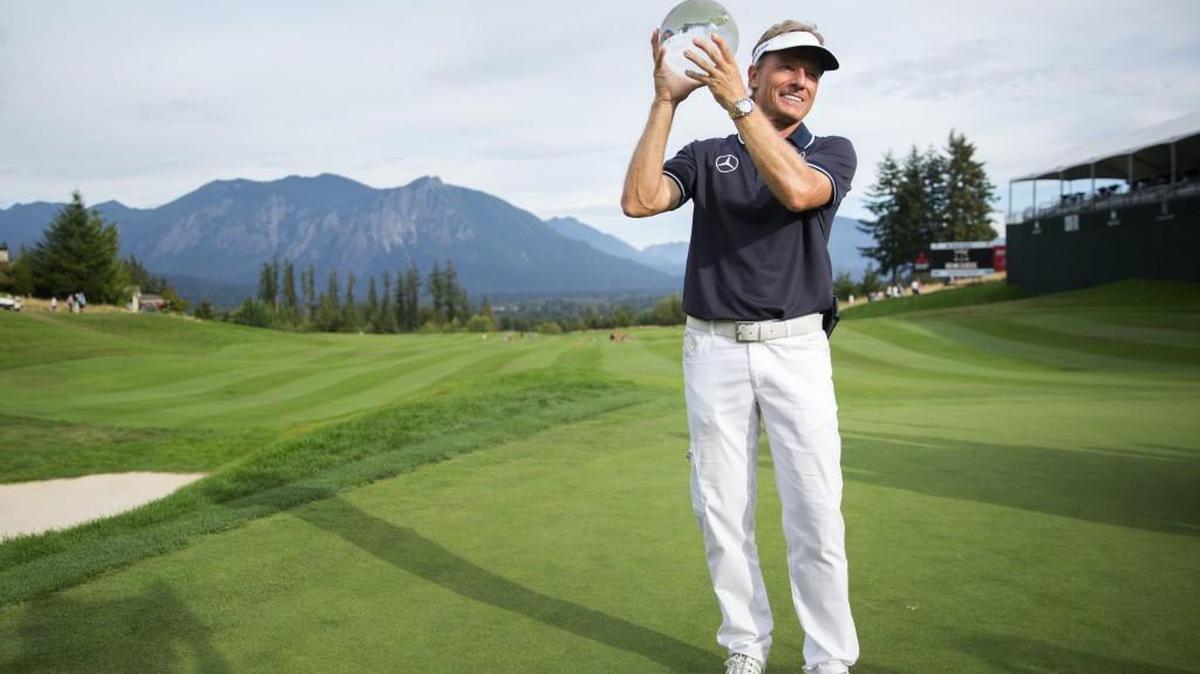 Bernhard Langer holds the glass trophy after winning his second Boeing Classic championship on Sunday. Langer birdied six of the final nine holes to force a three-way playoff.