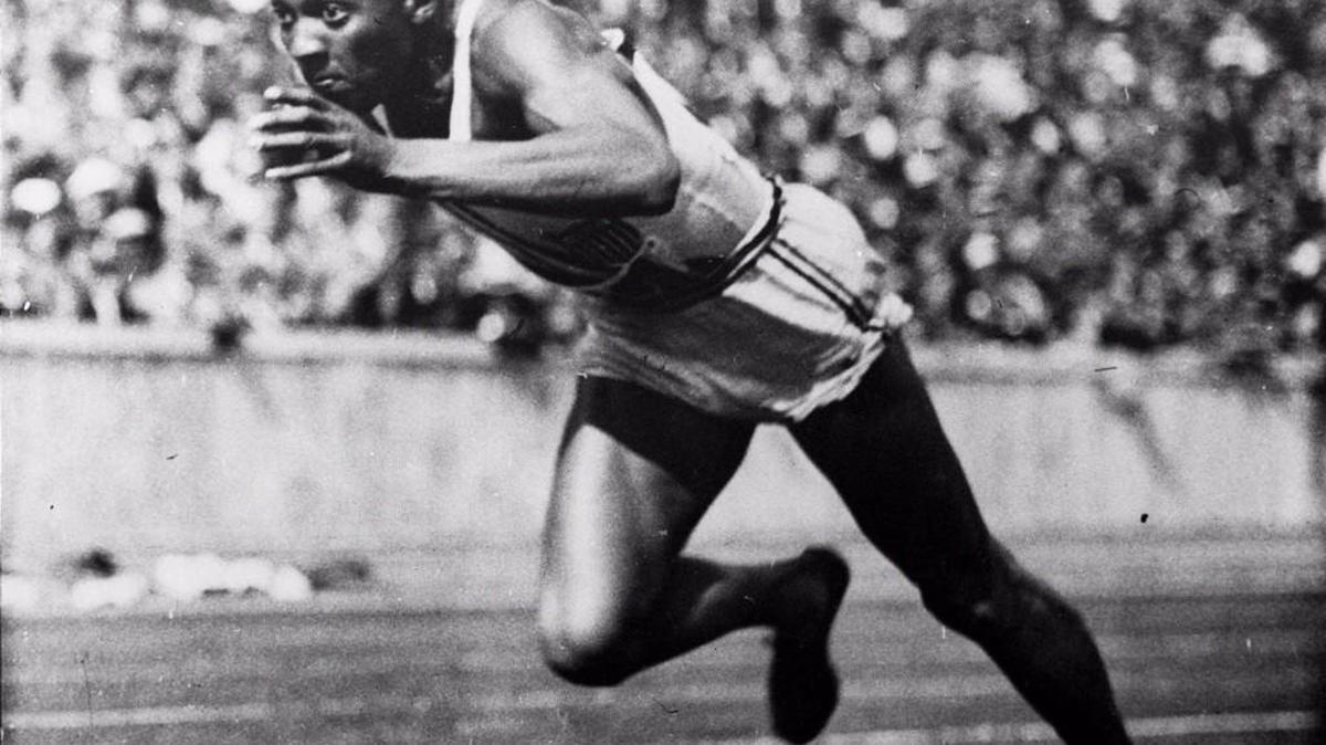 Jesse Owens starts a heat of the 200-meter dash at the 1936 Summer Olympics in Berlin. Owens went on to win four gold medals and break or tie Olympic records nine times.