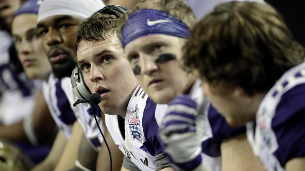 Washington quarterback Jake Browning, third from right, watches play from the bench Saturday during the second half of the Peach Bowl, in Atlanta. The Huskies’ 12-2 season and berth in the national semifinals raises the standard of excellence for the program.