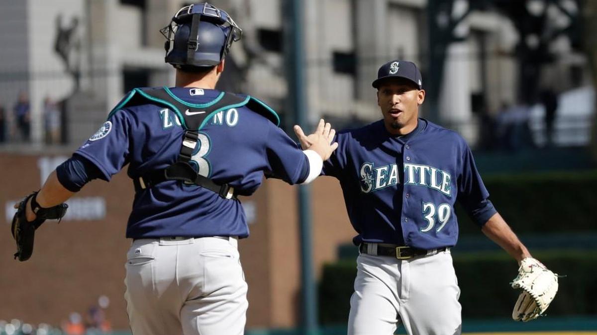 Seattle relief pitcher Edwin Diaz, right, greets catcher Mike Zunino after the last out in the ninth inning of a baseball game against the Detroit Tigers on April 27 in Detroit. Recent struggles have raised the question of how to get Diaz right again.