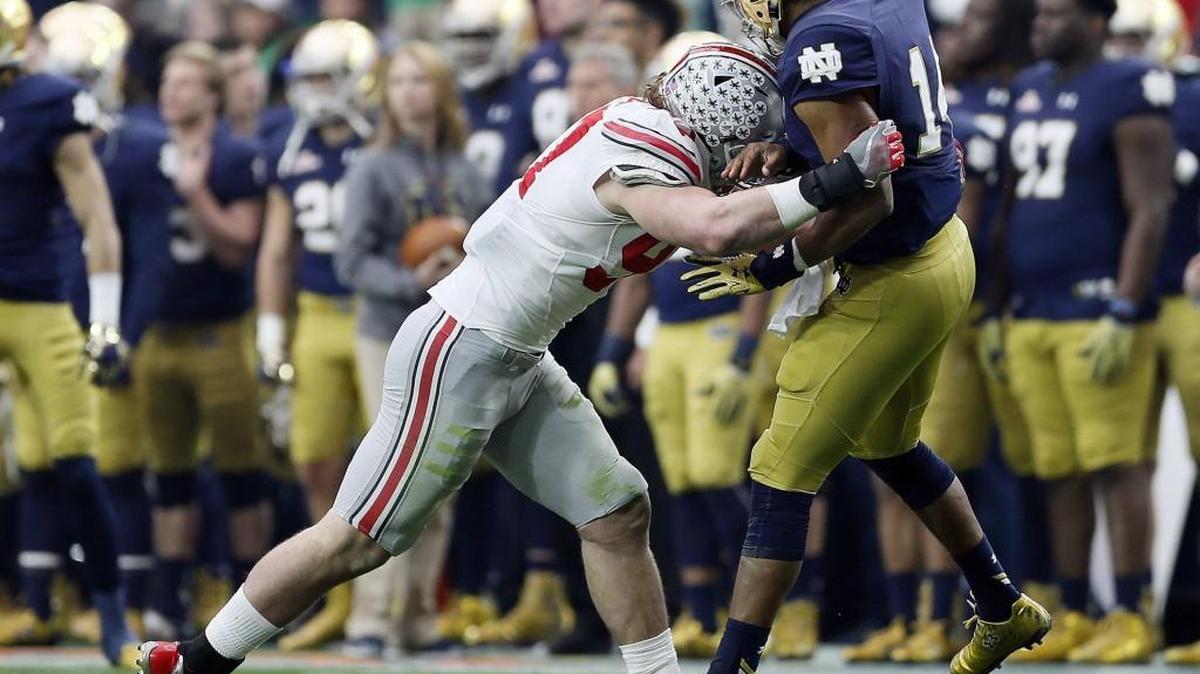 Ohio State defensive lineman Joey Bosa, left, hits Notre Dame quarterback DeShone Kizer during the Battlefrog Fiesta Bowl on Friday. Bosa was ejected from the game after the hit was ruled targeting by the officials.