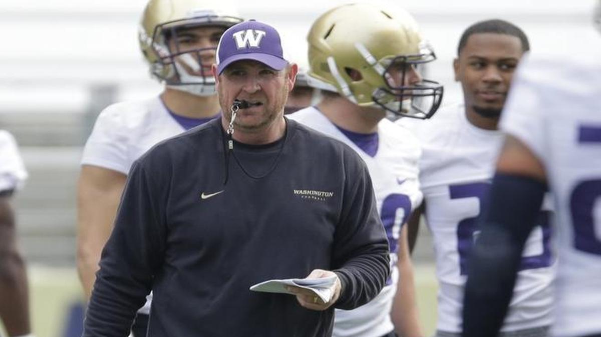 Washington defensive line and special teams coach Jeff Choate walks on the field during the first day of spring football practice March 30.