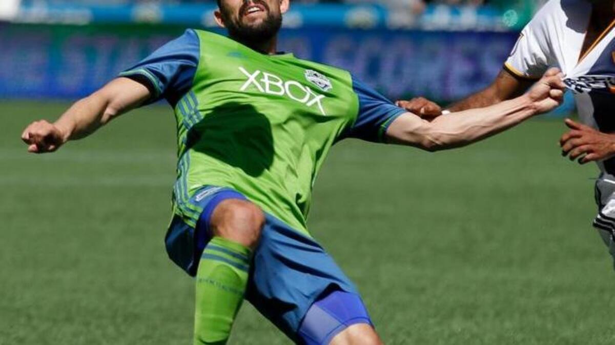 Seattle Sounders forward Herculez Gomez licks the ball during an MLS soccer match against the Los Angeles Galaxy, Sunday, July 31, 2016, in Seattle.