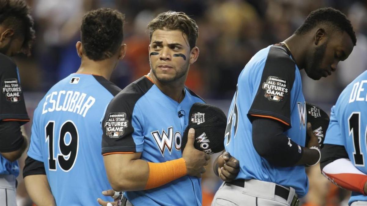 Yoan Moncada, center, stands for the national anthem before the All-Star Futures baseball game on Sunday in Miami. Moncada was selected to play in the Triple-A All-Star game on Wednesday but chose not to.