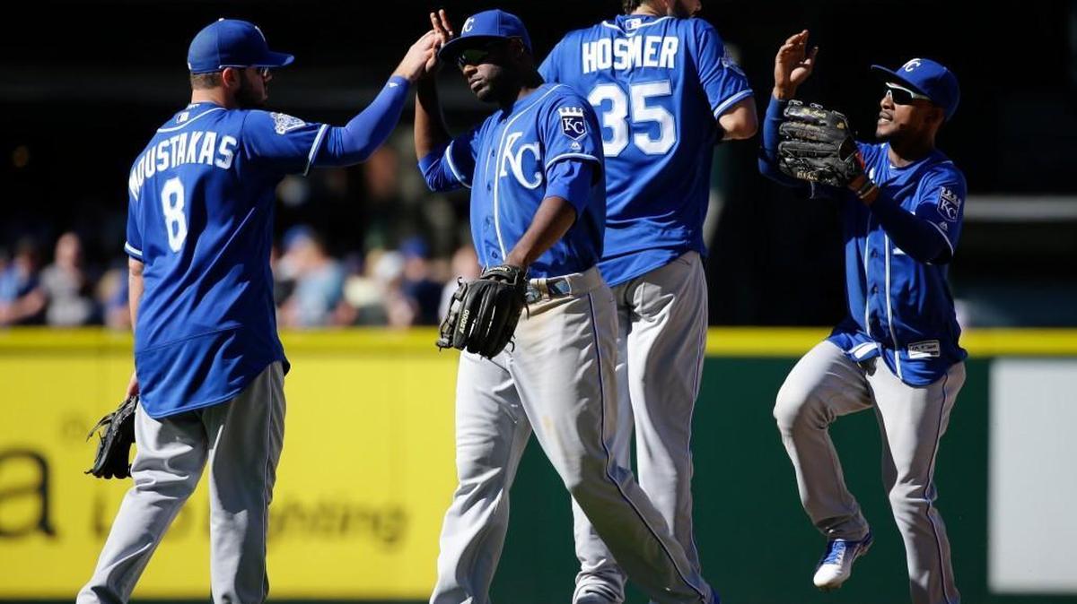 Royals players, from left, Mike Moustakas, Lorenzo Cain, Eric Hosmer, and Jarrod Dyson celebrate after Kansas City defeated the Mariners 4-1 at Safeco Field on Sunday.