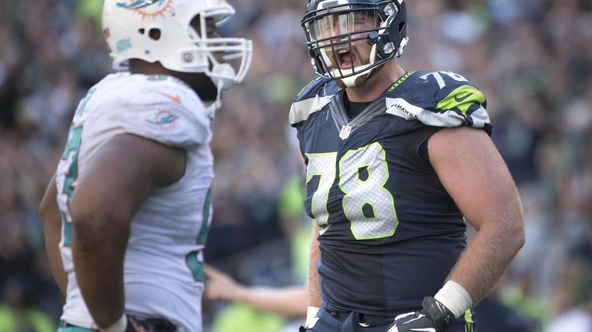 Seahawks offensive lineman Bradley Sowell lets out a roar in front of Dolphins linebacker Jelani Jenkins during Sunday's season opener at CenturyLink Field.
