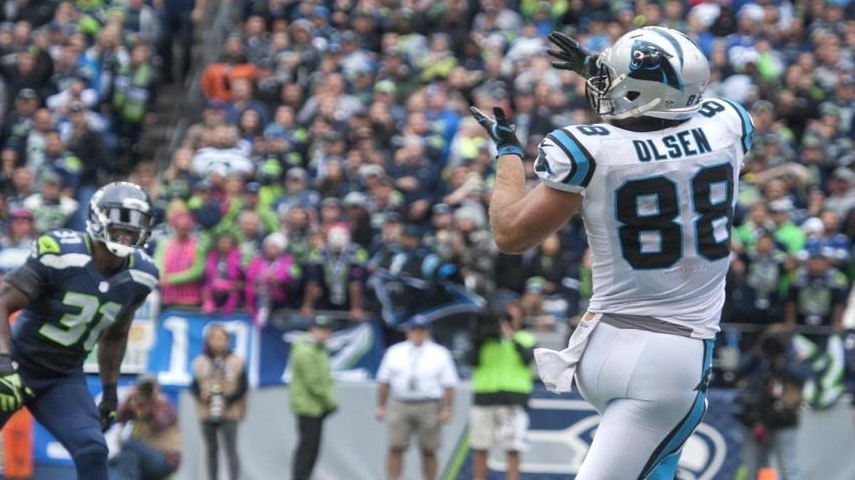 
Panthers tight end Greg Olsen catches the game-winning touchdown pass Sunday as Seahawks safety Kam Chancellor looks on. Seahawks defenders admitted after the game that they were playing different cover schemes. 
