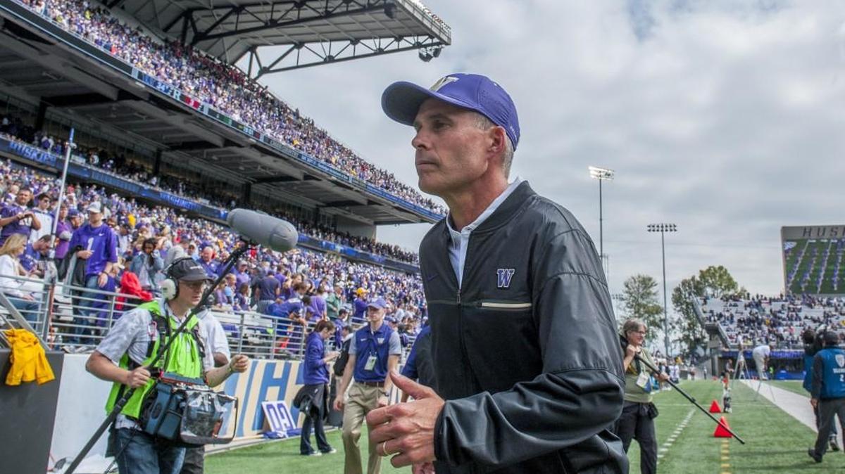 Coach Chris Petersen of University of Washington runs off the field at halftime in the season opening football game at Husky Stadium in Seattle, September 3, 2016. UW beat Rutgers, 48-13.