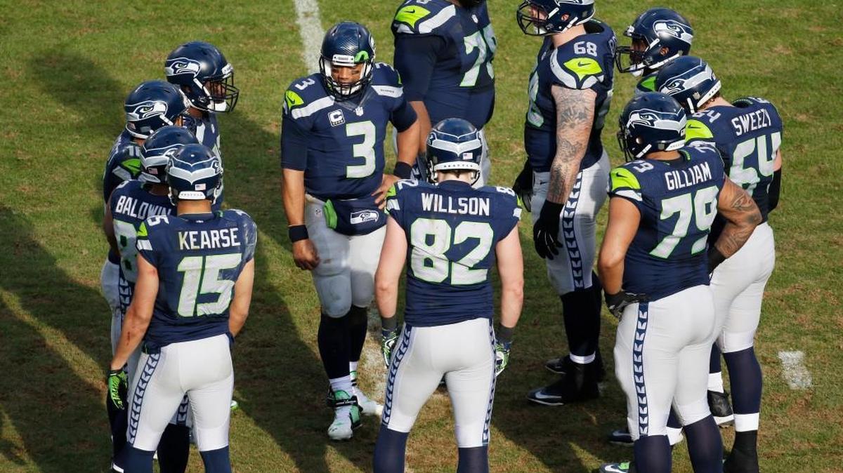 The Seattle Seahawks’ offense huddles during the second half Sunday under the leadership of quarterback Russell Wilson (3) against the Carolina Panthers on Sunday.