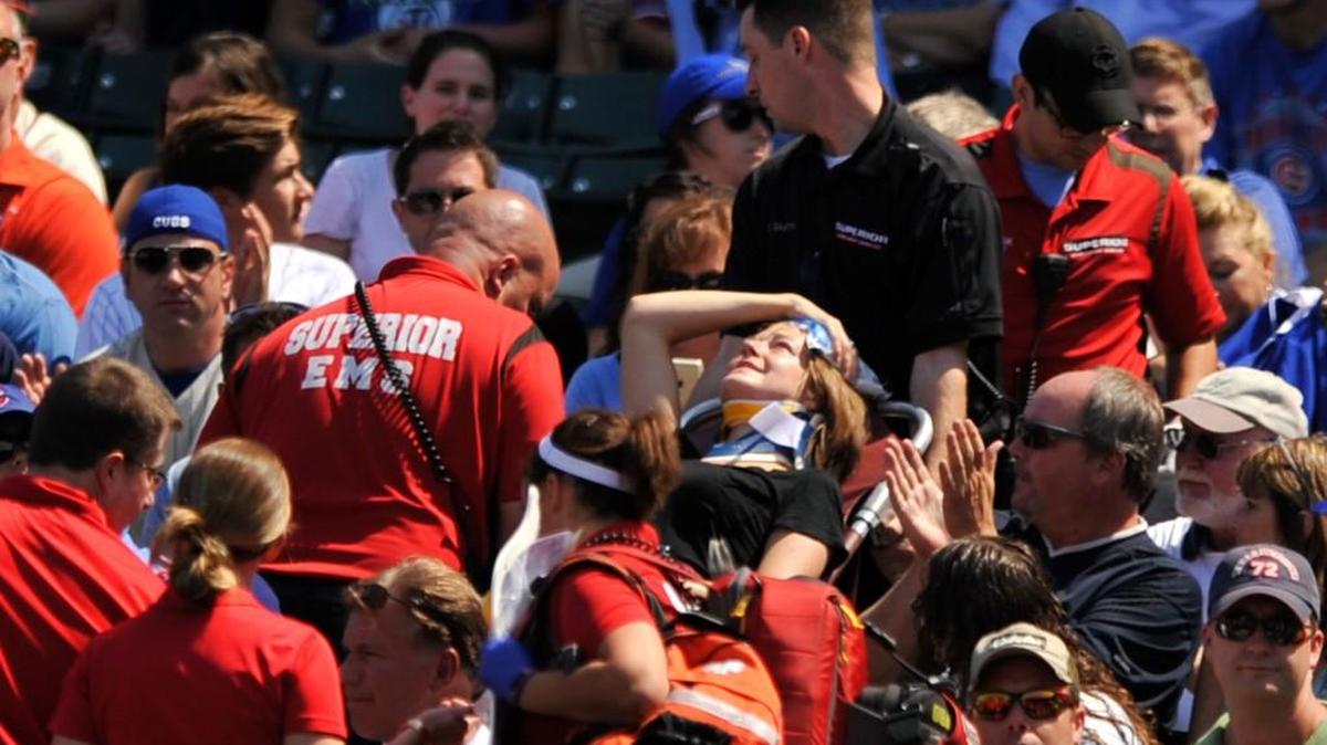 
A woman is carried from the Wrigley Field stands on a stretcher after being hit a by a line-drive foul ball during the first inning of the Cubs-Braves game in Chicago on Sunday. 
