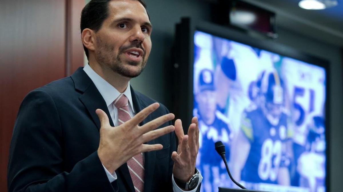 This June 25, 2015 file photo shows Dean Blandino, vice president of officiating for the NFL, presenting the new technology that the NFL uses in the prevention and diagnosis of injuries, during a league news conference on Capitol Hill in Washington. The chop block has been entirely outlawed from NFL games, and extra-point kicks snapped from the 15-yard line are now permanent.