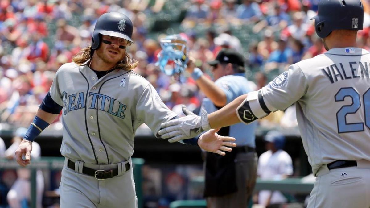 Seattle’s Ben Gamel, left, is congratulated by Danny Valencia (26) on Sunday after scoring on a double by Kyle Seager in the first inning against the Rangers. The Mariners have 16 of their next 19 game at home, and need to make the most of them after an abysmal road trip.